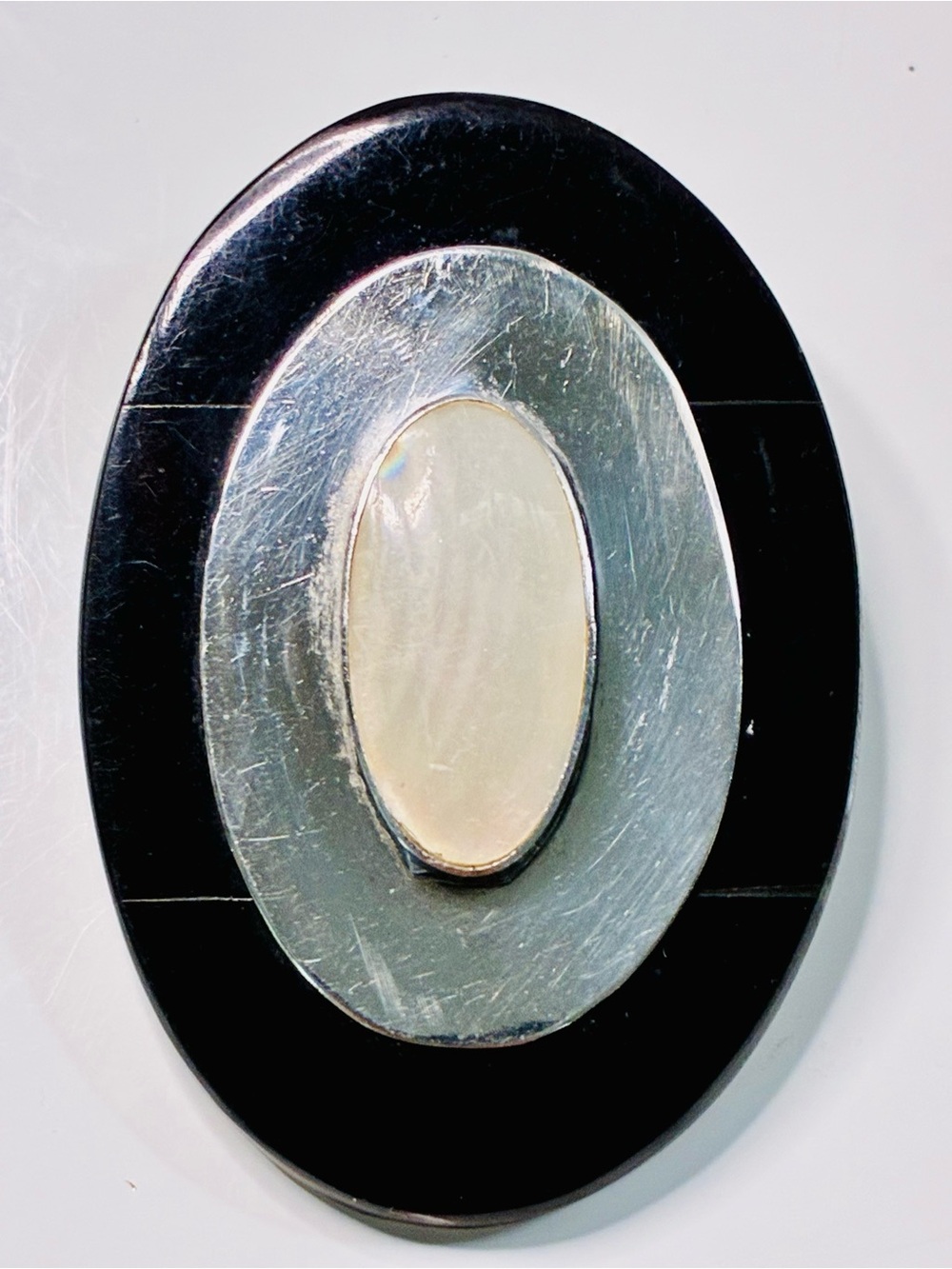 Elevated Simple Black and Silver Oval Brooch with Mother-of-Pearl Center Pendant